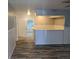 Inviting open-concept area featuring plank flooring and wainscoting connecting to additional rooms at 4802 Drift Tide Dr, New Port Richey, FL 34652