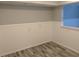 Cozy room showcasing wainscoting, gray paint, and plank flooring with a recessed light overhead at 4802 Drift Tide Dr, New Port Richey, FL 34652