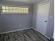 A well-lit room featuring fresh paint, modern flooring, and a unique glass block window detail at 4802 Drift Tide Dr, New Port Richey, FL 34652