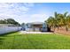 Charming home featuring a covered patio and fenced-in backyard with lush green grass at 487 49Th N Ave, St Petersburg, FL 33703