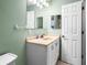 Bathroom vanity featuring a sink, white cabinet, and a framed mirror at 487 49Th N Ave, St Petersburg, FL 33703