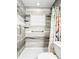Bathroom shower with decorative tile, grab bars, shower curtain, and a small window at 487 49Th N Ave, St Petersburg, FL 33703