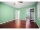 Bedroom with a closet and hardwood floors, leading to an open door and view into the bathroom at 487 49Th N Ave, St Petersburg, FL 33703