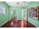 Bedroom featuring hardwood floors, sliding mirrored closet doors, and an open door to the bathroom at 487 49Th N Ave, St Petersburg, FL 33703