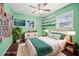 Bedroom featuring natural light from two windows, hardwood floors, and a ceiling fan at 487 49Th N Ave, St Petersburg, FL 33703