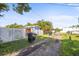 Long driveway leading to property, enclosed by fencing and lush greenery, offering ample parking space at 487 49Th N Ave, St Petersburg, FL 33703