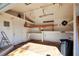 Well-lit garage interior featuring workbench and storage, ideal for hobbies or projects, with 'Grandpa's Workshop' sign at 487 49Th N Ave, St Petersburg, FL 33703