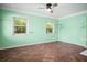 Light-filled living room features tile floors, large windows, and a ceiling fan at 487 49Th N Ave, St Petersburg, FL 33703