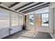 Bright sunroom featuring multiple windows offering views of the outdoors, complete with neutral carpet flooring at 487 49Th N Ave, St Petersburg, FL 33703