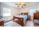 Bright bedroom with a wood-framed bed, neutral walls, and a ceiling fan for added comfort at 509 N Washington Ave, Clearwater, FL 33755