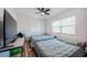 Serene bedroom with two twin beds, wood-look floors, and soft natural light, creating a cozy retreat at 509 N Washington Ave, Clearwater, FL 33755