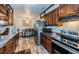 Well-equipped kitchen featuring stainless steel appliances, dark wood cabinets, and a dining area for casual meals at 509 N Washington Ave, Clearwater, FL 33755