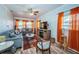 Comfortable living room featuring wood-look floors, a ceiling fan, and ample seating for relaxation and entertainment at 509 N Washington Ave, Clearwater, FL 33755