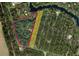 Aerial view showing home nestled on a large lot surrounded by mature trees and outlined property lines at 5540 Cyril Dr, Dade City, FL 33523