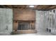 Unfinished basement features a brick fireplace with wood mantel and exposed utilities at 5540 Cyril Dr, Dade City, FL 33523