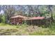 Exterior shot of sheds on a property with lush greenery and mature trees surrounding the buildings at 5540 Cyril Dr, Dade City, FL 33523