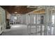 View of the home's interior in the middle of renovation with exposed framing and original fireplace at 5540 Cyril Dr, Dade City, FL 33523