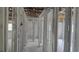 Unfinished interior featuring white painted support structures, large windows, and exposed ceiling beams at 5540 Cyril Dr, Dade City, FL 33523