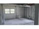 Unfinished room with white-painted support structures, large windows, and exposed utilities at 5540 Cyril Dr, Dade City, FL 33523