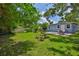 Relaxing backyard with patio seating, fire pit, and lush green lawn perfect for outdoor gatherings and Gathering fun at 5840 39Th N St, St Petersburg, FL 33714