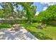 Spacious backyard featuring a concrete patio, seating area, and a fire pit for outdoor entertaining and relaxation at 5840 39Th N St, St Petersburg, FL 33714