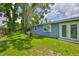 Expansive backyard featuring lush green grass, mature trees, and a privacy fence at 5840 39Th N St, St Petersburg, FL 33714
