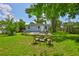 Expansive backyard with a fire pit, patio, and mature trees creating a serene and private outdoor space at 5840 39Th N St, St Petersburg, FL 33714