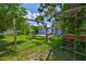 Spacious backyard offers seating, fire pit, lush greenery, and mature trees at 5840 39Th N St, St Petersburg, FL 33714