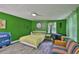 Comfortable bedroom with green walls, unique decor, and natural light at 5840 39Th N St, St Petersburg, FL 33714