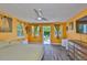 Comfortable bedroom featuring wood floors, ceiling fan, dresser, and access to outdoor patio at 5840 39Th N St, St Petersburg, FL 33714