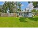 Inviting home with a lush green front yard, decorative fence, and a charming porch creating a welcoming curb appeal at 5840 39Th N St, St Petersburg, FL 33714