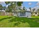 Charming home featuring a well-maintained front yard and cozy porch with chairs, perfect for enjoying the outdoors at 5840 39Th N St, St Petersburg, FL 33714