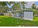 Quaint home with a beautiful front yard, well-kept lawn, and a cozy porch area with seating for relaxation at 5840 39Th N St, St Petersburg, FL 33714