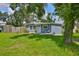 Lovely home featuring a well-manicured front lawn, inviting porch, and charming details enhancing its curb appeal at 5840 39Th N St, St Petersburg, FL 33714