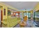 The living room flows into the kitchen. The floors are wood-look and the lighting is modern at 5840 39Th N St, St Petersburg, FL 33714