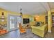 The living room has wood-look floors, and an abundance of natural light coming through the french doors to the patio at 5840 39Th N St, St Petersburg, FL 33714