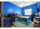 Bedroom with a bed, ceiling fan, window, and desk in front of the bright blue walls at 603 Bainbridge Dr, Brandon, FL 33511
