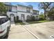 Charming townhome exterior showcasing multiple units, allocated parking, and mature trees for curb appeal at 603 Bainbridge Dr, Brandon, FL 33511