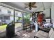 Enclosed porch with a ceiling fan, outdoor furniture, and an array of items stored on the floor at 603 Bainbridge Dr, Brandon, FL 33511