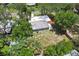 Lush backyard with trees surrounds the home; aerial view showcases the tranquil neighborhood at 607 E River Dr, Temple Terrace, FL 33617