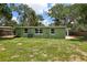 Large backyard with grass and mature trees at 607 E River Dr, Temple Terrace, FL 33617