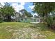 Large backyard with grass and mature trees at 607 E River Dr, Temple Terrace, FL 33617
