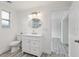 Bright bathroom with vanity and modern light fixture, featuring light wood flooring at 607 E River Dr, Temple Terrace, FL 33617