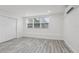 Well-lit bedroom showcasing light wood flooring, a closet, and a window offering natural light at 607 E River Dr, Temple Terrace, FL 33617
