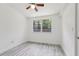 Bright bedroom features a large window and wood-look floors at 607 E River Dr, Temple Terrace, FL 33617