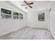 Bright bedroom with vaulted ceiling, multiple windows, ceiling fan, and light wood flooring at 607 E River Dr, Temple Terrace, FL 33617