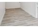 A clean and well-lit room showcasing modern light wood flooring with crisp, white trim at 607 E River Dr, Temple Terrace, FL 33617