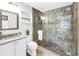 Modern bathroom featuring a glass-enclosed shower, granite countertops, and ample natural light at 610 Cordova Ne Blvd, St Petersburg, FL 33704