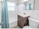 Clean bathroom with white subway tile, bathtub, modern fixtures, and plenty of natural light at 610 Cordova Ne Blvd, St Petersburg, FL 33704