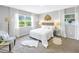 Bright bedroom features two windows and neutral decor, creating a serene and inviting atmosphere at 610 Cordova Ne Blvd, St Petersburg, FL 33704